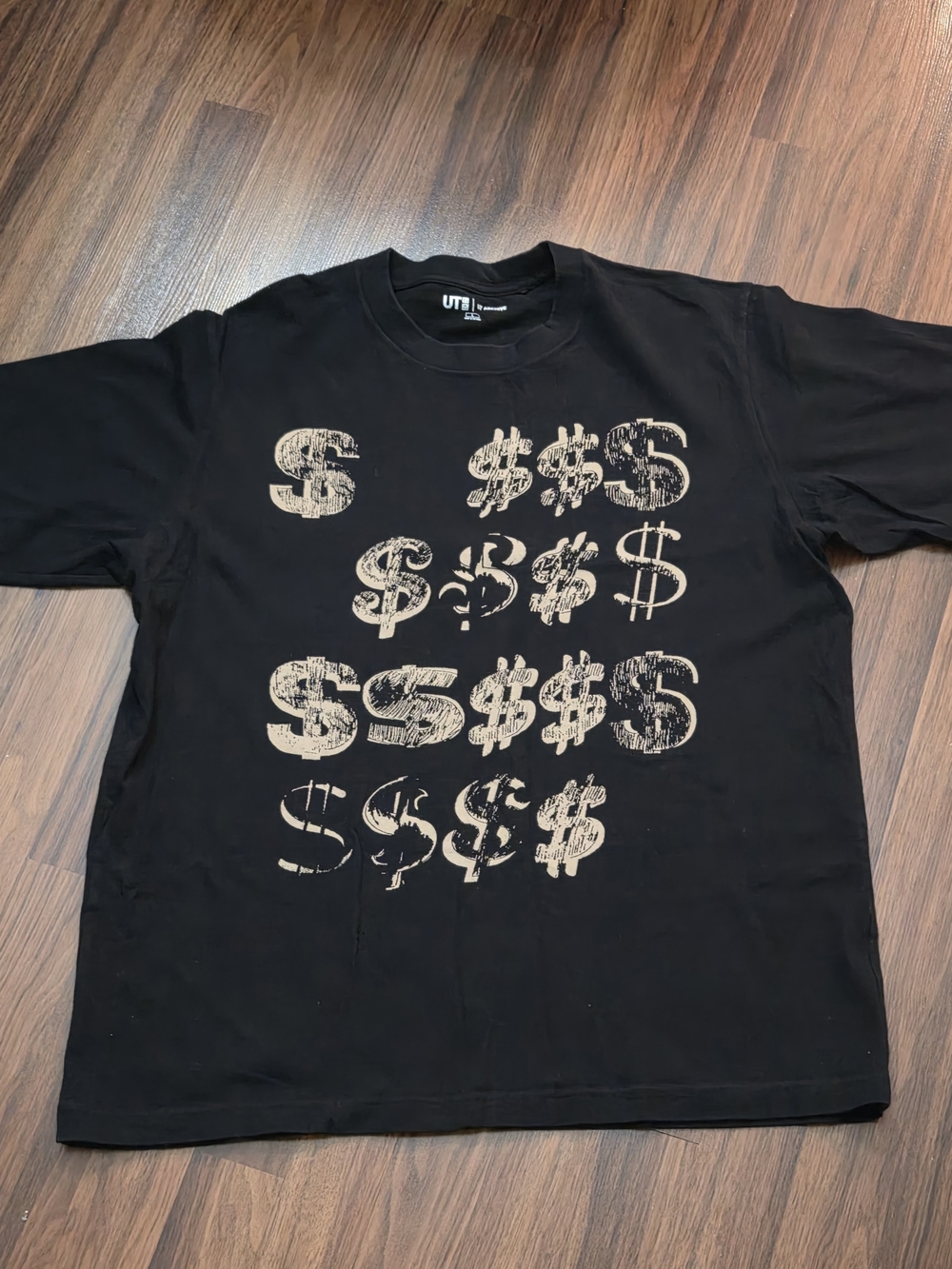 Uniqlo Black Short-Sleeve Tee with Tan Dollar Sign Graphic